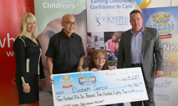 50/50 Plus lottery winner Elizabeth Garcia (seated) and her husband Antonio (second from left) receive their big cheque from LHSF Chief Operating Officer Evelyn Salhani (left) and CHF President & CEO Scott Fortnum (right).