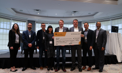 Kirk and Joanne Baines hold a giant cheque with doctors and LHSF CEO